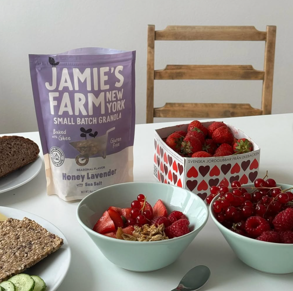 Jamie's Farm New York granola with strawberries and red currants on a table.