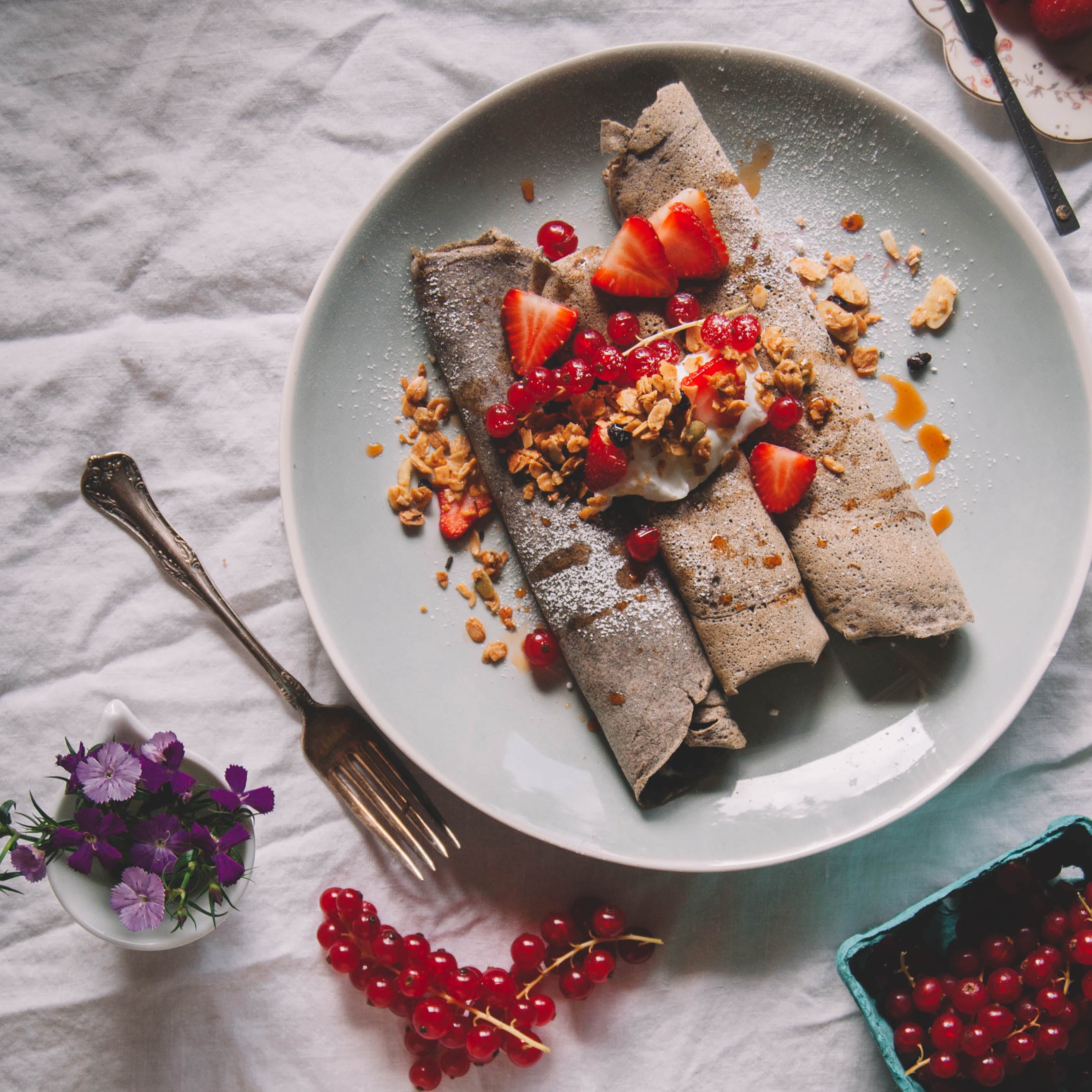 Jamie's Farm Granola Buckwheat Crepes with Gluten-Free Rosemary Granola baked with Ghee, and topped with Strawberries and Currants