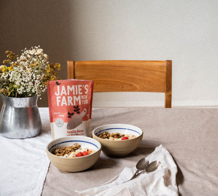 Breakfast scene with cereal granola and bowls on a table.