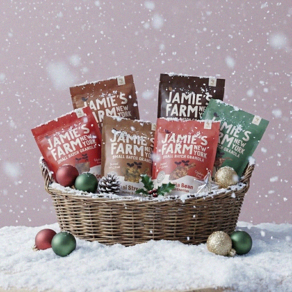 Basket of Jamie's Farm New York products with Christmas decorations on a snowy background
