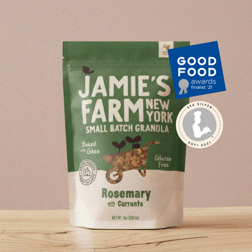 A stand-up pouch of Jamie's Farm New York Small Batch Granola, Rosemary with Currants flavor, displayed on a light wooden surface against a solid beige background. The packaging is green and white with a blue Good Food Awards 2021 badge and a Silver Spoon award badge overlaid on the top right.